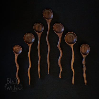 Seven wooden spoons, on a black background