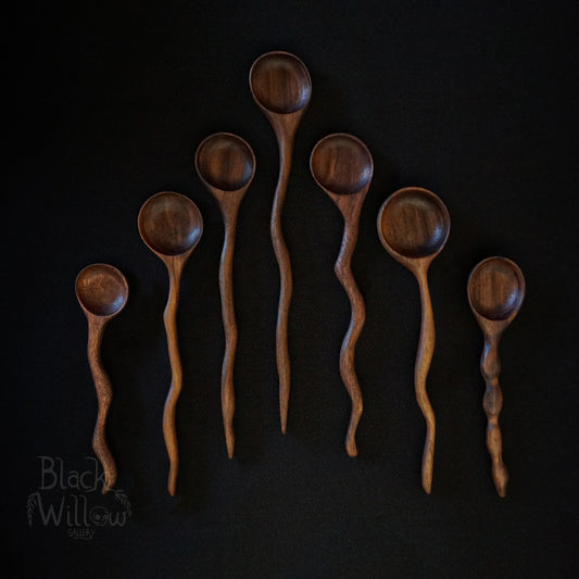 Seven wooden spoons, on a black background